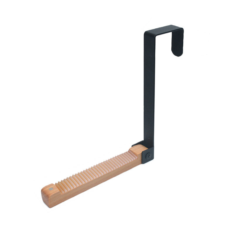 Foldable door hook in wood and metal, shown on a door, an essential for home organization.