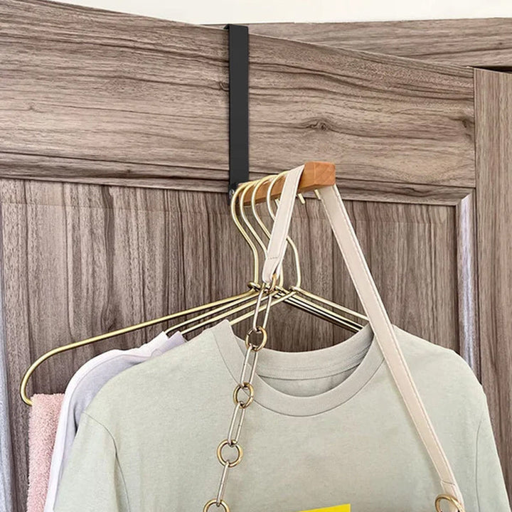 Over-the-door hook extended, ready for use, featuring a blend of wood and metal for home organization.