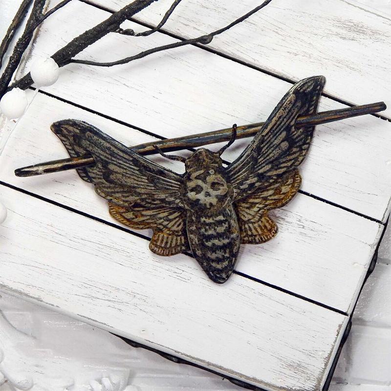Gothic women's hair pin, skull and moth design, made from metal with faux bone accents, a standout hair accessory.
