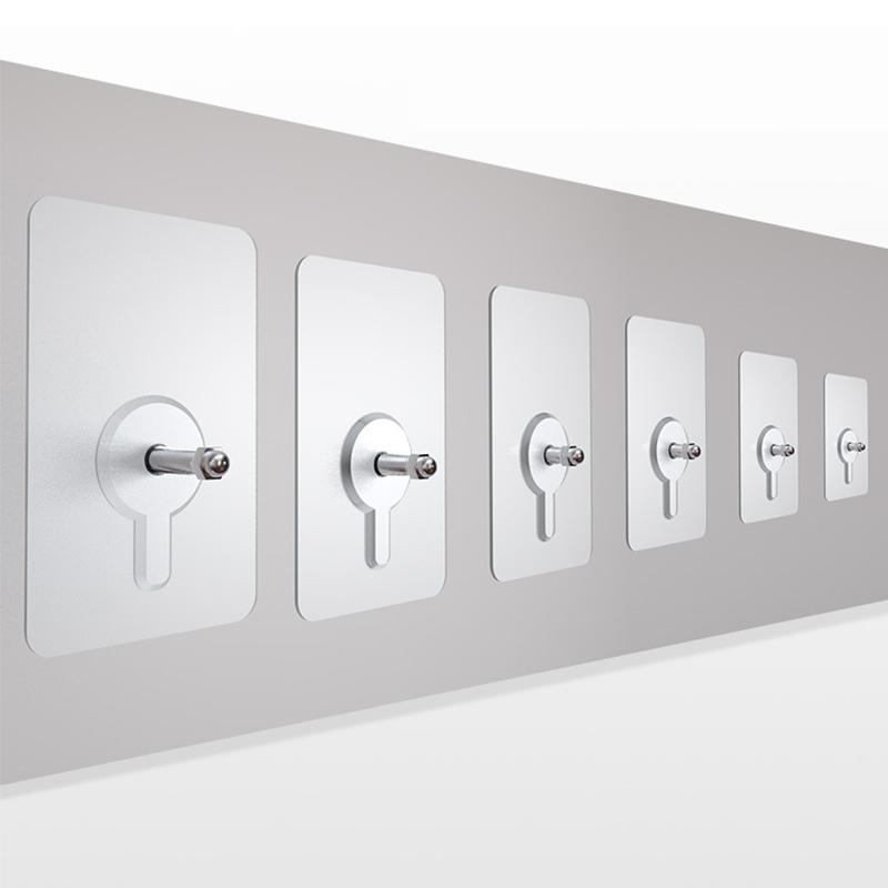Reusable, no-drill adhesive wall hanger in a bathroom setting, holding an accessory