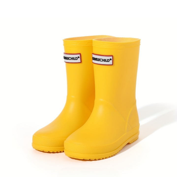Close-up of kids' waterproof wellies, showing non-slip sole & durable material for outdoor play.