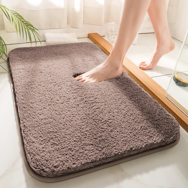 "Luxurious plush microfiber bath rug with non-slip backing, beige color, offers ultimate softness and superior absorbency."