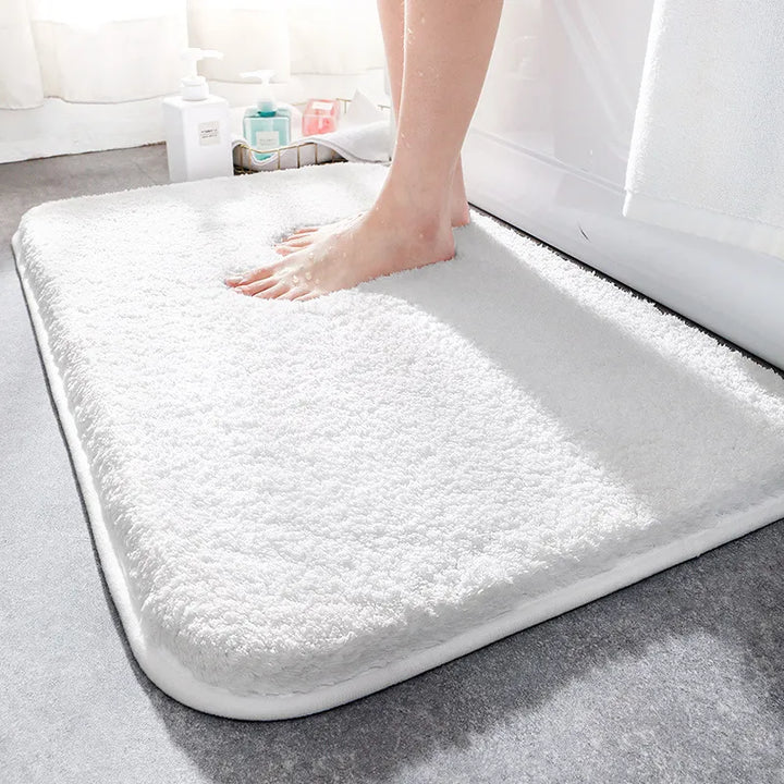 "Luxurious plush microfiber bath rug with non-slip backing, beige color, offers ultimate softness and superior absorbency."