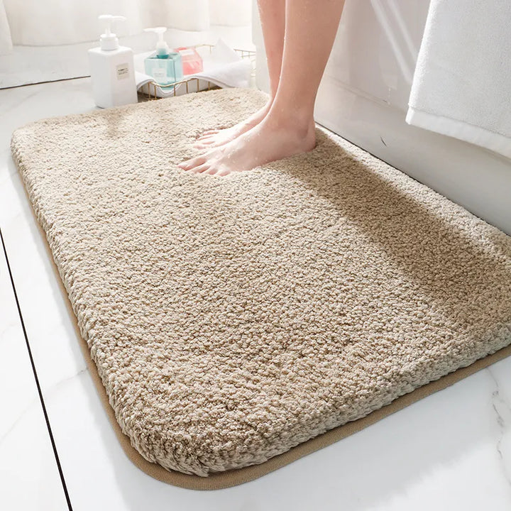 "Luxurious plush microfiber bath rug with non-slip backing, beige color, offers ultimate softness and superior absorbency."
