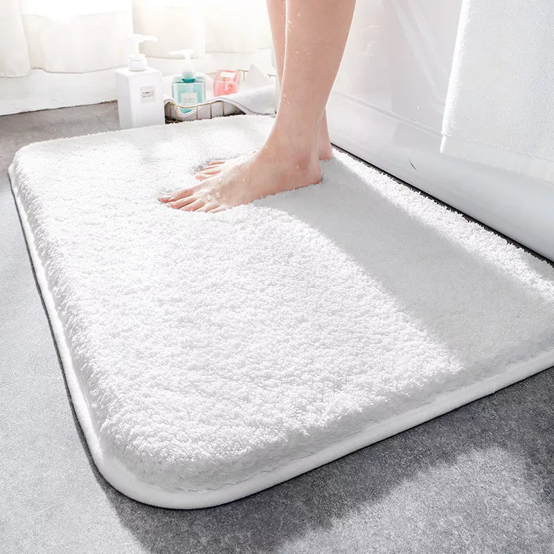"Luxurious plush microfiber bath rug with non-slip backing, beige color, offers ultimate softness and superior absorbency."