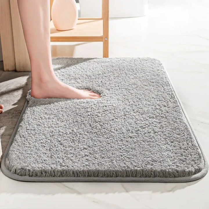 "Luxurious plush microfiber bath rug with non-slip backing, beige color, offers ultimate softness and superior absorbency."