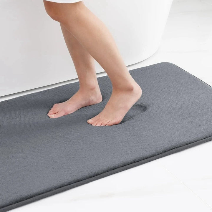 "Luxurious velvet bath mat with memory foam, anti-slip backing, plush coral surface, available in assorted colors and sizes."