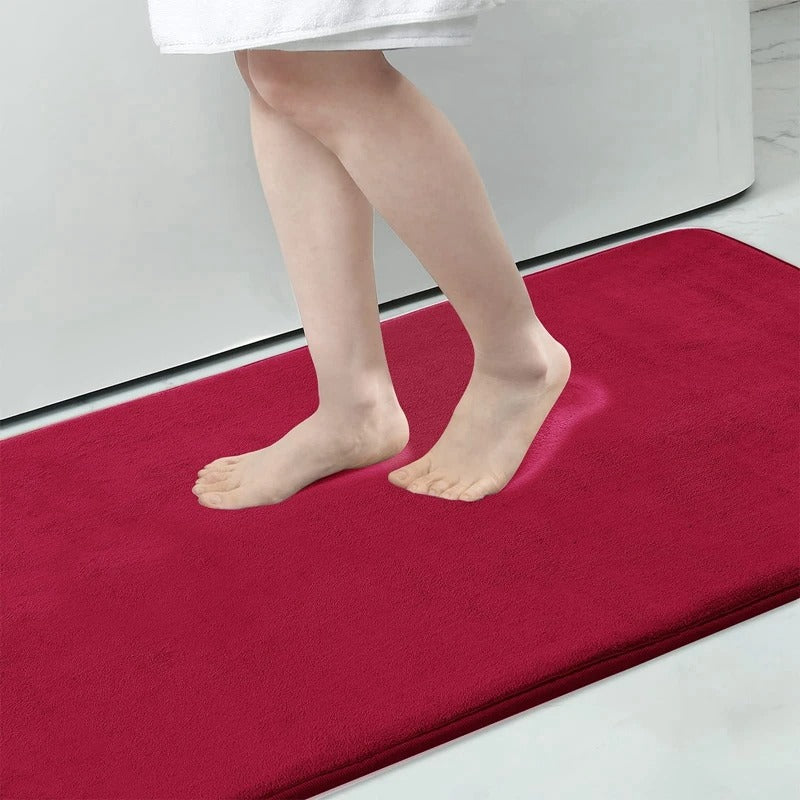 "Luxurious velvet bath mat with memory foam, anti-slip backing, plush coral surface, available in assorted colors and sizes."