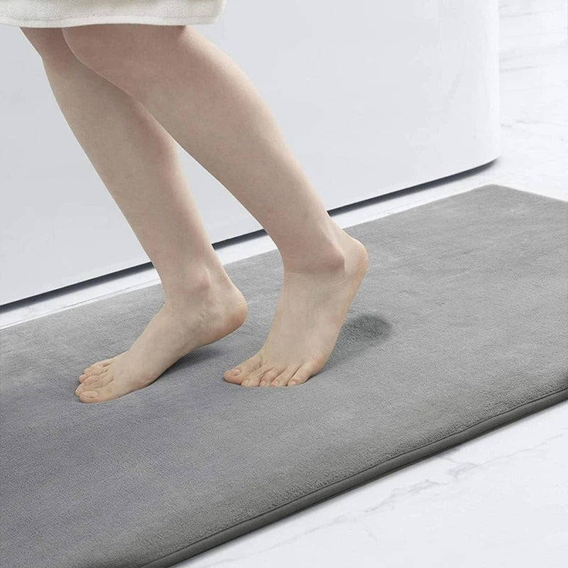 "Luxurious velvet bath mat with memory foam, anti-slip backing, plush coral surface, available in assorted colors and sizes."