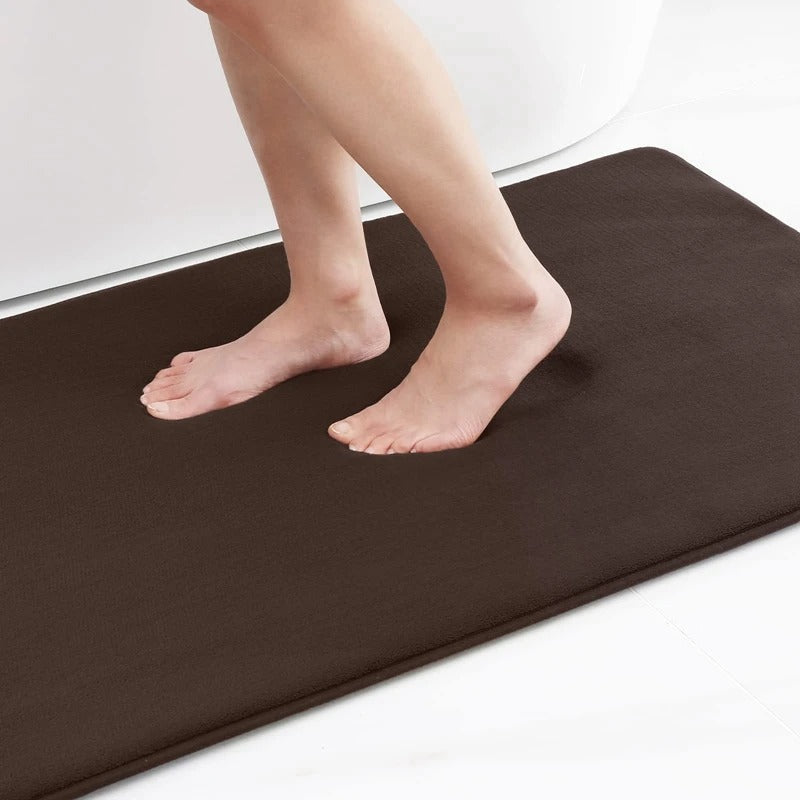"Luxurious velvet bath mat with memory foam, anti-slip backing, plush coral surface, available in assorted colors and sizes."