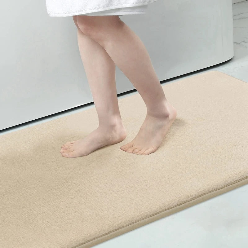 "Luxurious velvet bath mat with memory foam, anti-slip backing, plush coral surface, available in assorted colors and sizes."
