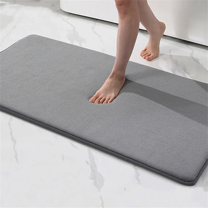 "Luxurious velvet bath mat with memory foam, anti-slip backing, plush coral surface, available in assorted colors and sizes."
