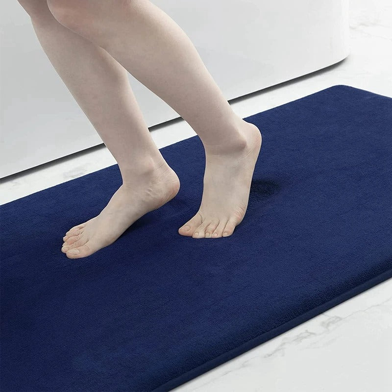 "Luxurious velvet bath mat with memory foam, anti-slip backing, plush coral surface, available in assorted colors and sizes."