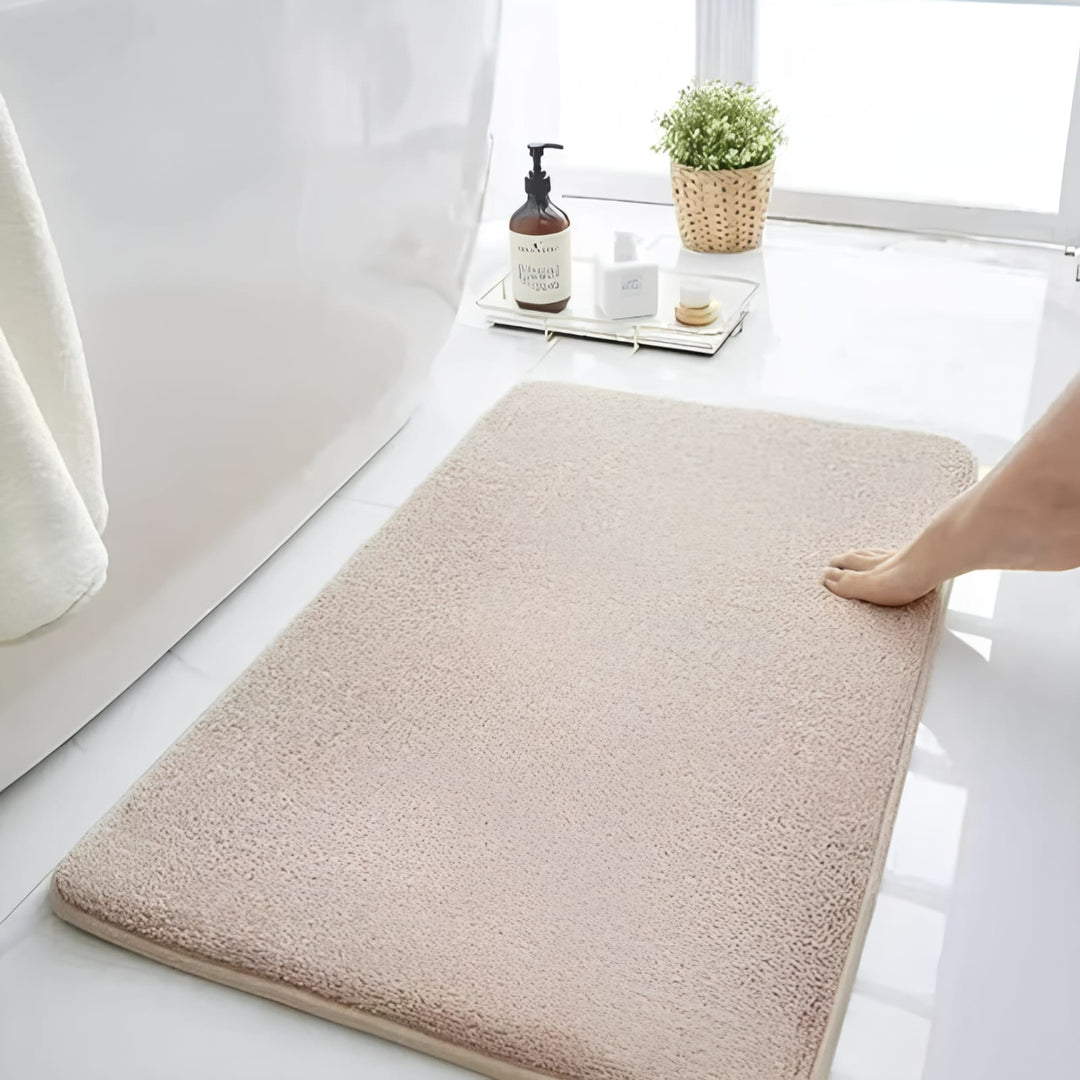 "Luxurious velvet bath mat with memory foam, anti-slip backing, plush coral surface, available in assorted colors and sizes."