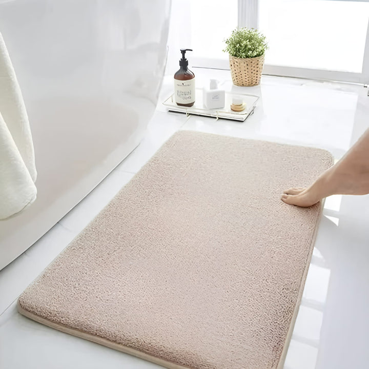 "Luxurious velvet bath mat with memory foam, anti-slip backing, plush coral surface, available in assorted colors and sizes."