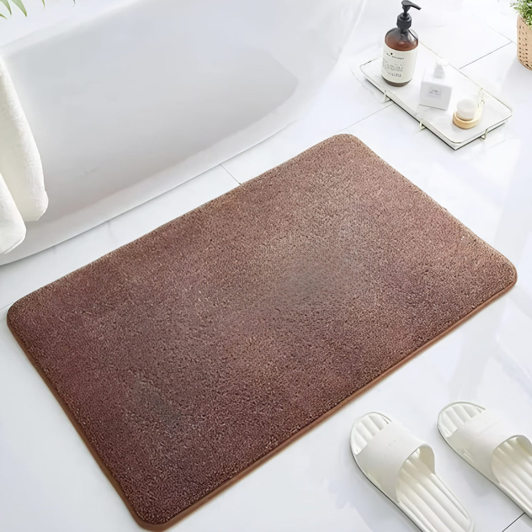 "Luxurious velvet bath mat with memory foam, anti-slip backing, plush coral surface, available in assorted colors and sizes."