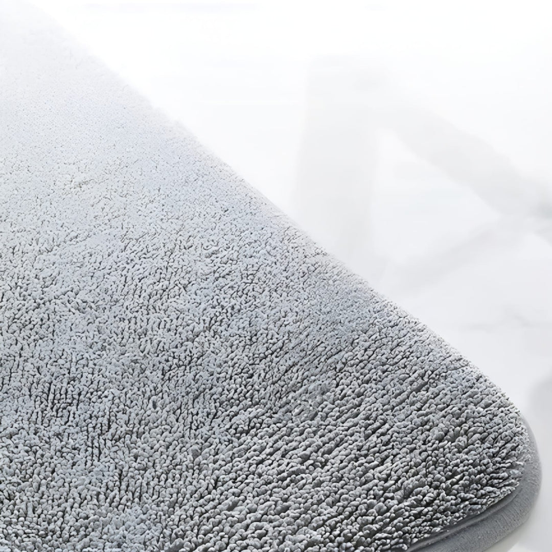 "Luxurious velvet bath mat with memory foam, anti-slip backing, plush coral surface, available in assorted colors and sizes."