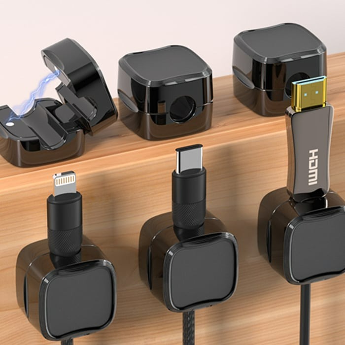 Magnetic Cable Organizer Clip with adhesive base, securely holding a USB cable in a car