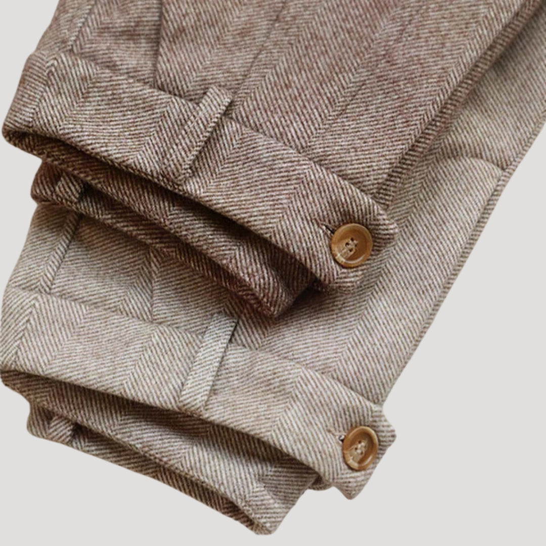 Close-up of the fabric texture of men's tailored ankle-length pants, showing quality craftsmanship.