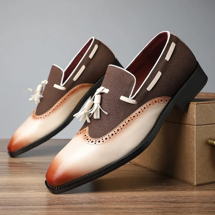 Elegant men's dress shoes: burgundy leather tassel loafers featuring classic brogue design.