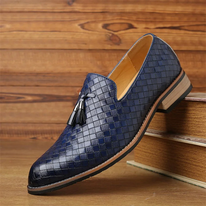 Sole of men's dress shoes, textured tassel loafers, indicating durable construction