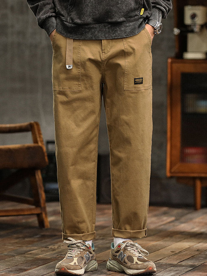 Khaki men's multi-pocket vintage utility pants, relaxed fit, great for outdoor adventures.
