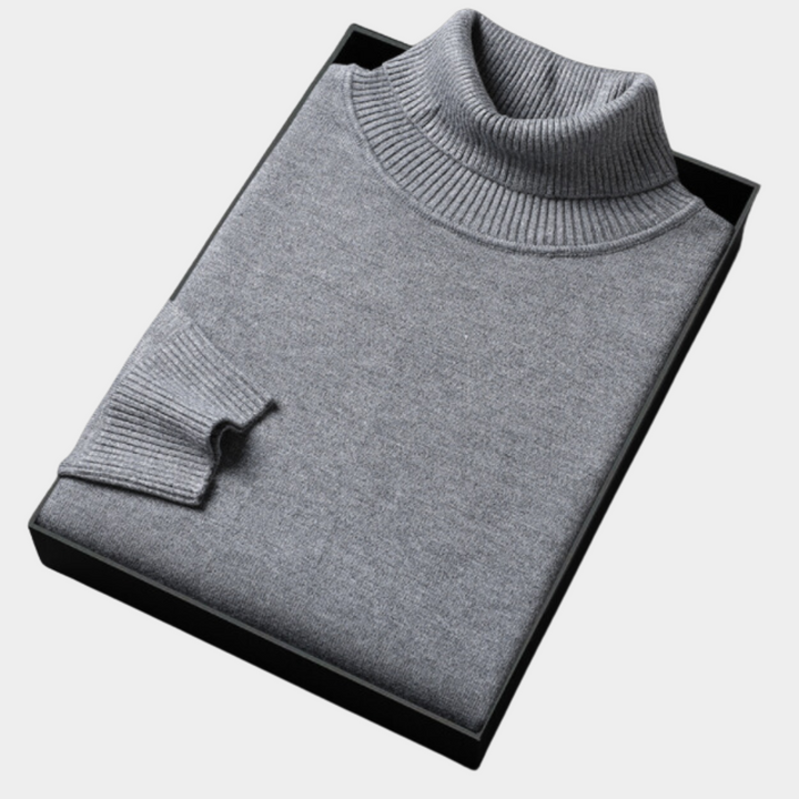 Front view of a men's bold orange turtleneck sweater, highlighting its vibrant color and knit design.
