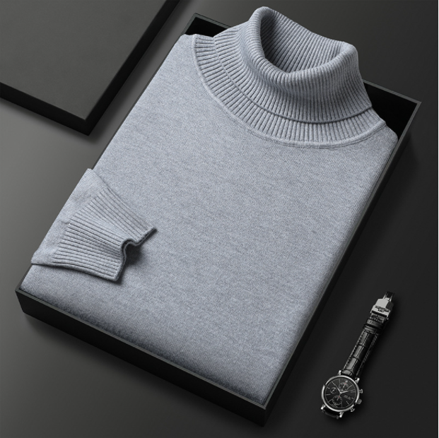 Folded men's camel-colored turtleneck sweater, a classic spring fashion item, showcasing its neat appearance.