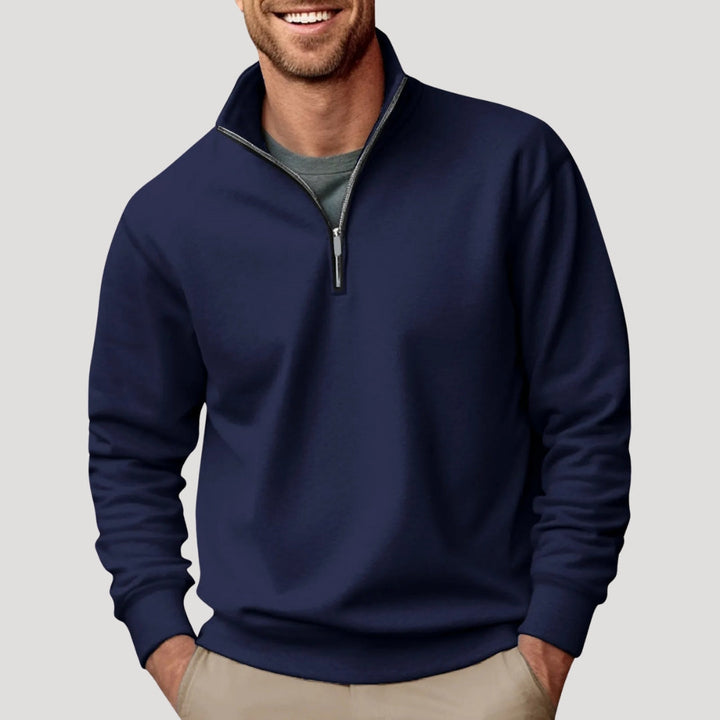Close-up of the quarter zip detail on a black men's sweatshirt, showcasing quality & comfort.