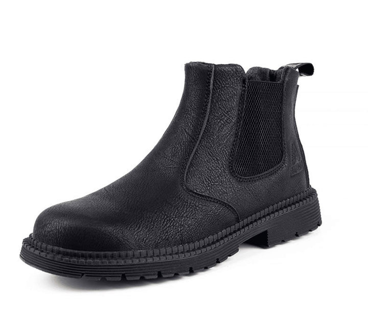 Close-up of men's brown leather Chelsea boot, showcasing elastic side panel and pull tab for easy slip-on