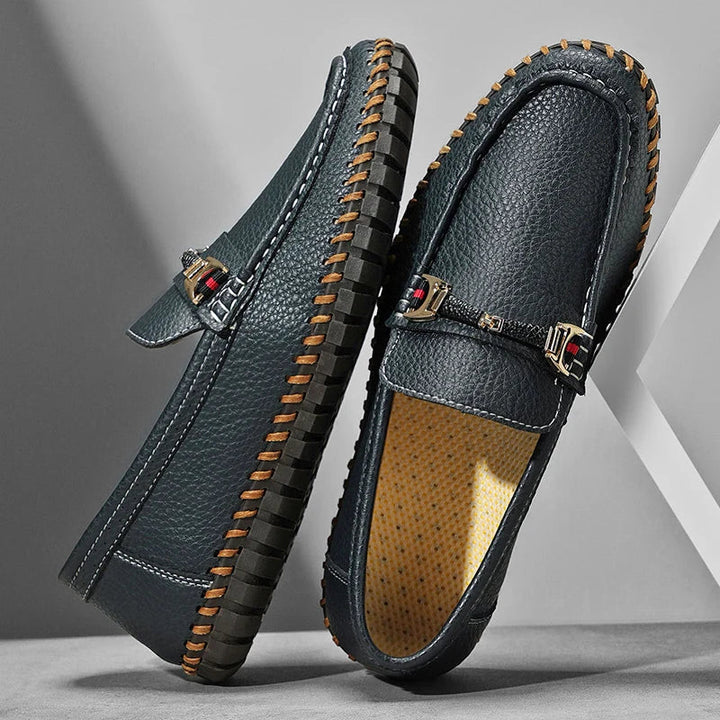 Close-up texture of men's full-grain leather bit loafers, emphasizing premium material and design
