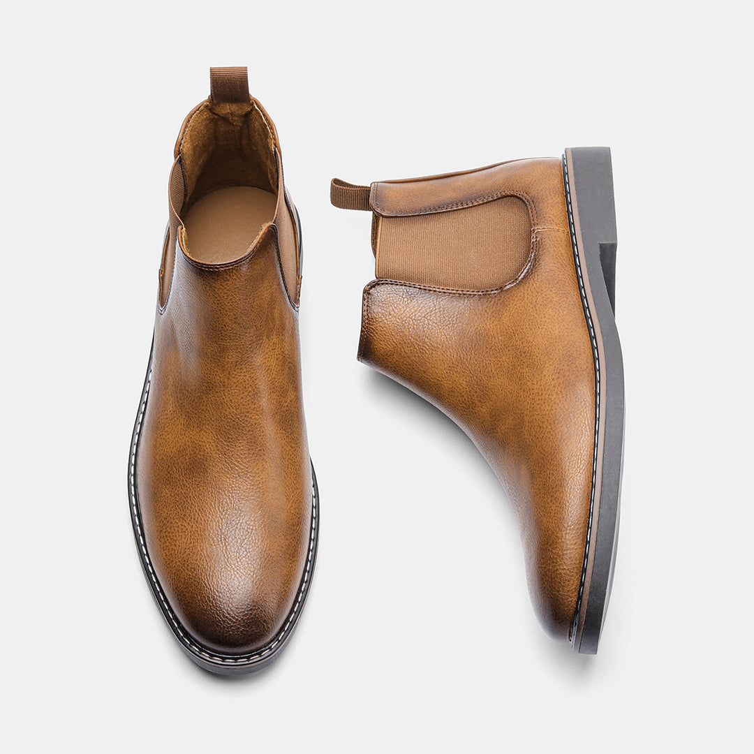 Side profile of men's dress Chelsea boots, showcasing the elegant silhouette and craftsmanship
