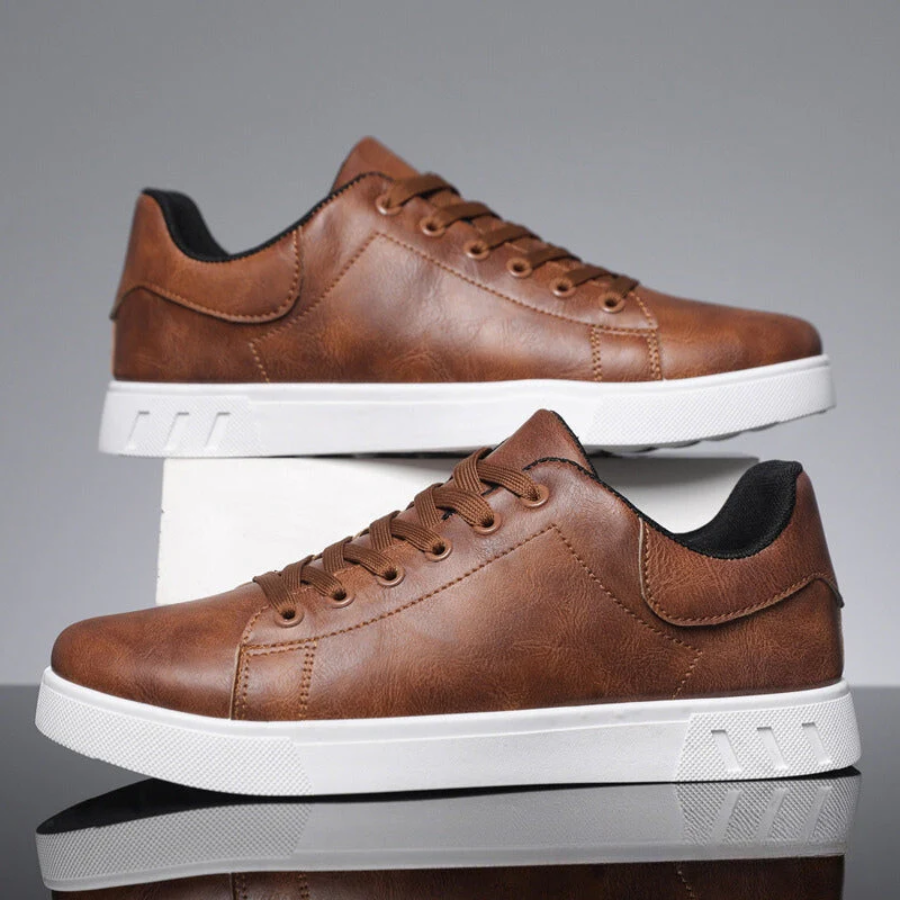 Close-up of men's classic white low-top sneakers, showing textured upper and laces