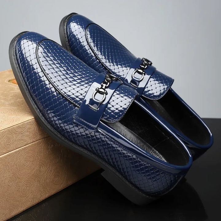Close-up of the sole of men's embossed leather loafers, highlighting quality craftsmanship and grip.