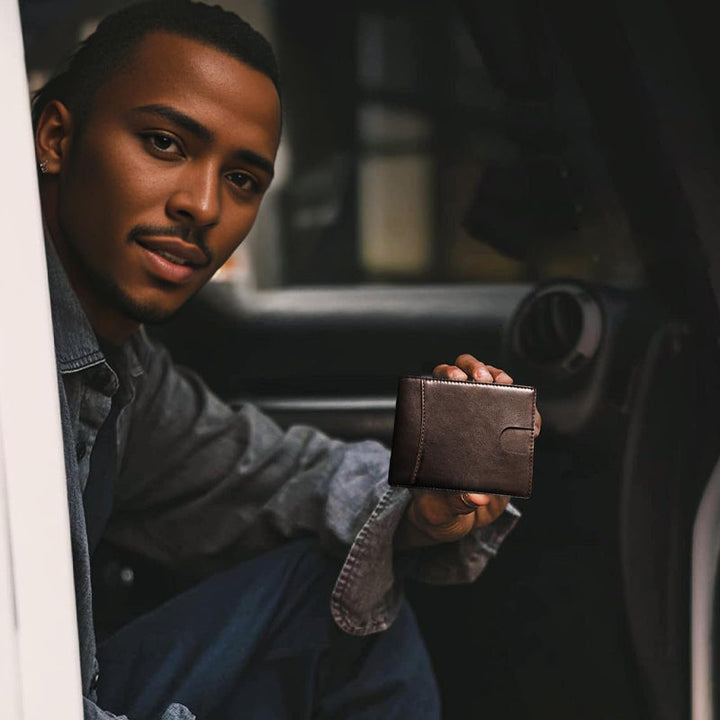 Hand holding a black genuine leather minimalist RFID wallet, showcasing slimness