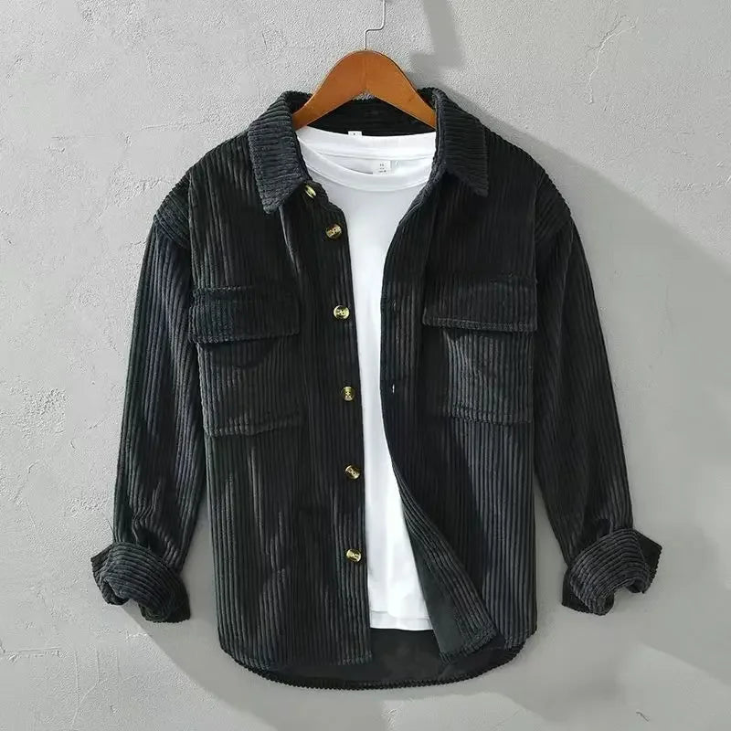 Close-up of ribbed corduroy fabric on a men's button down overshirt in olive green