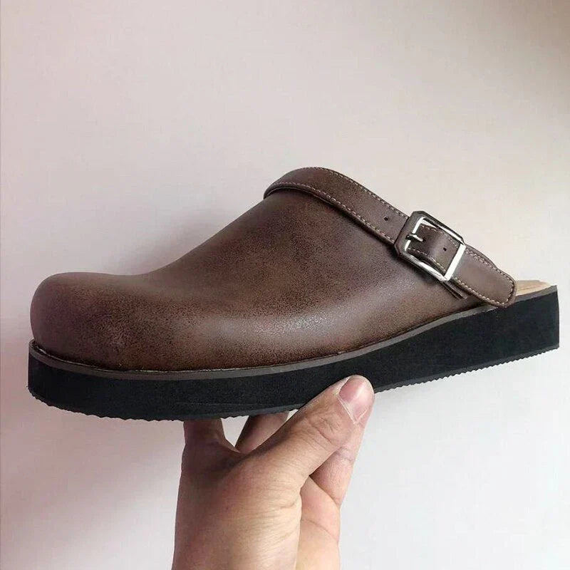 High-angle view of men's luxury leather clogs, emphasizing their sleek and sophisticated look.