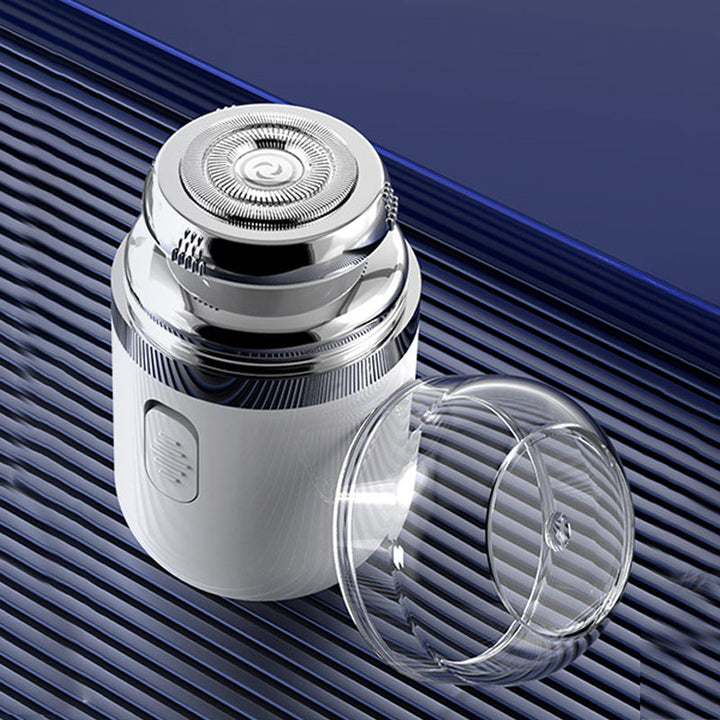 Compact electric beard trimmer with a protective cap, perfect for travel and quick shaves