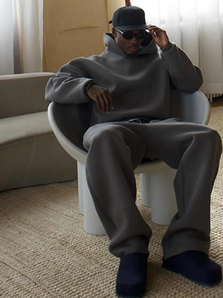 Versatile men's oversized tracksuit set with hoodie and joggers. A relaxed fit casual outfit for modern men.