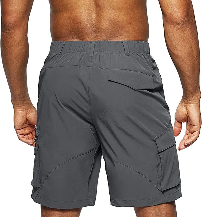 Folded green men's quick-dry cargo shorts, ready for travel and adventure.