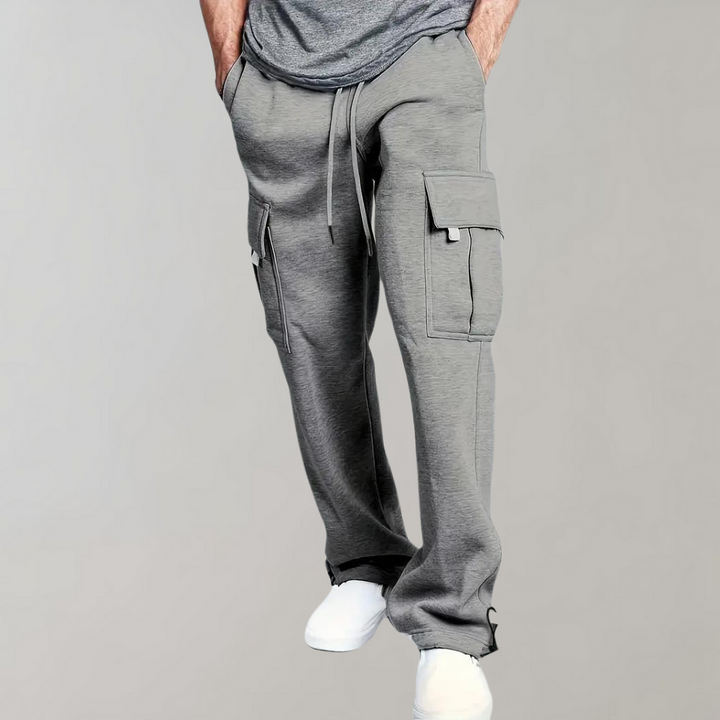 Men's relaxed fit cargo pants in a neutral color, showcasing multiple utility pockets on the side