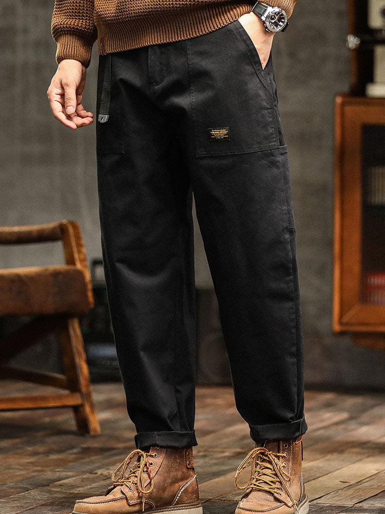 Durable men's utility pants in a relaxed fit, showcasing spacious cargo pockets and a comfortable design.