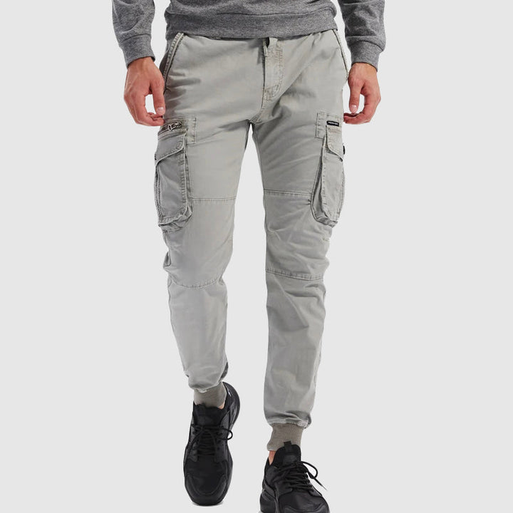 Men's slim fit utility cargo jogger pants in black, showcasing tapered leg and multi-pockets for modern streetwear style.