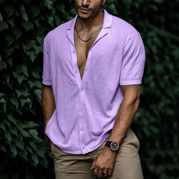 Back view of a man in a relaxed fit textured short sleeve Cuban collar shirt. Great for summer style.