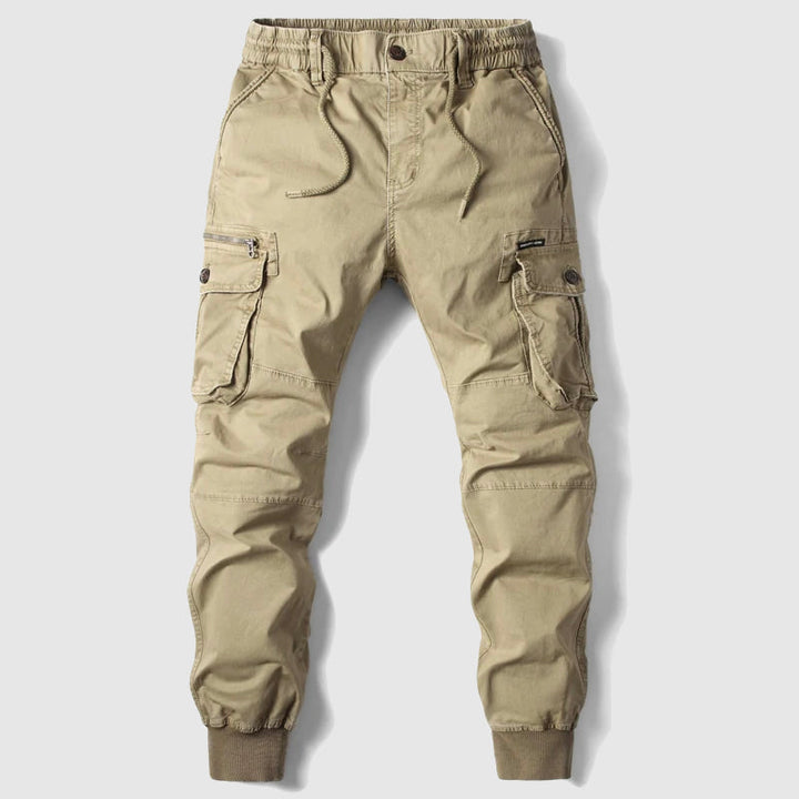 Close-up of men's cargo jogger pants pockets with durable fabric, highlighting utility and style.