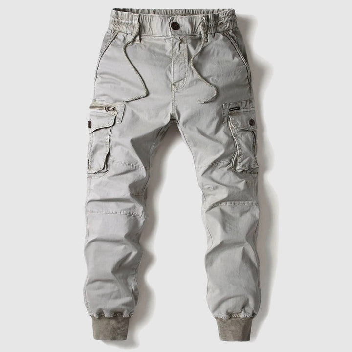 Side view of men's utility cargo jogger pants, emphasizing the cuffed ankles and relaxed fit.
