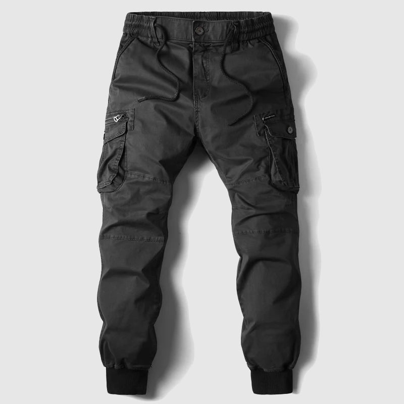 Stack of folded men's durable cargo jogger pants in various colors, ready for men's fashion.