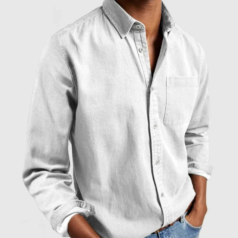 Men's vintage long sleeve button-down shirt. Casual chambray top, perfect for relaxed everyday fashion.