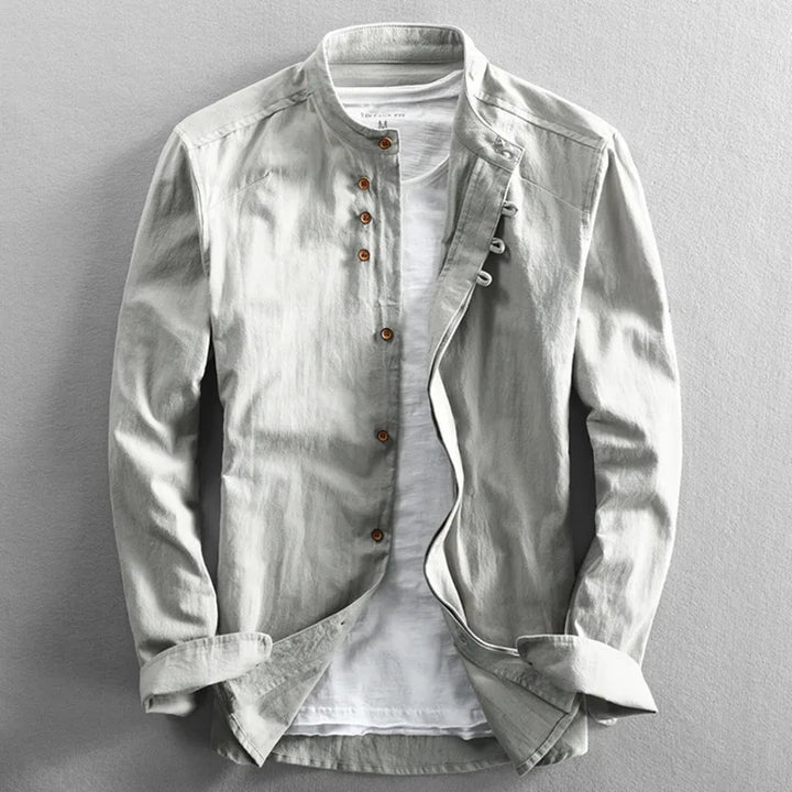 Stack of folded men's white cotton-linen band collar shirts, ready for shipping