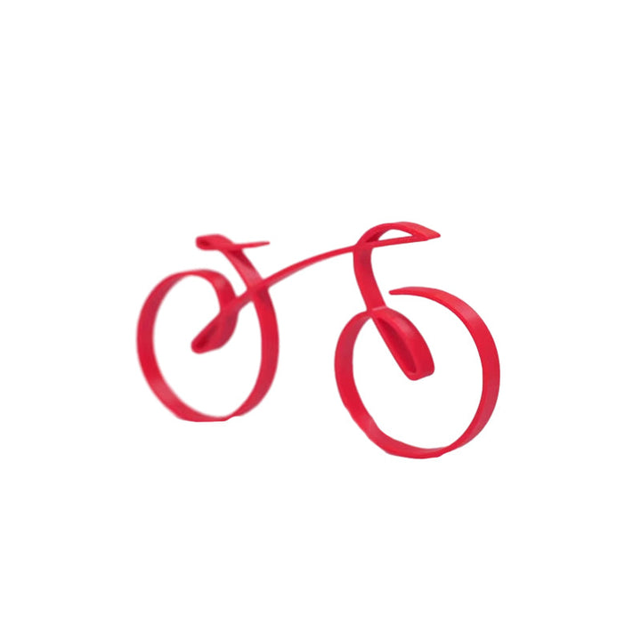 Minimalist bicycle sculpture atop a stack of books, sophisticated desk decor for home or office